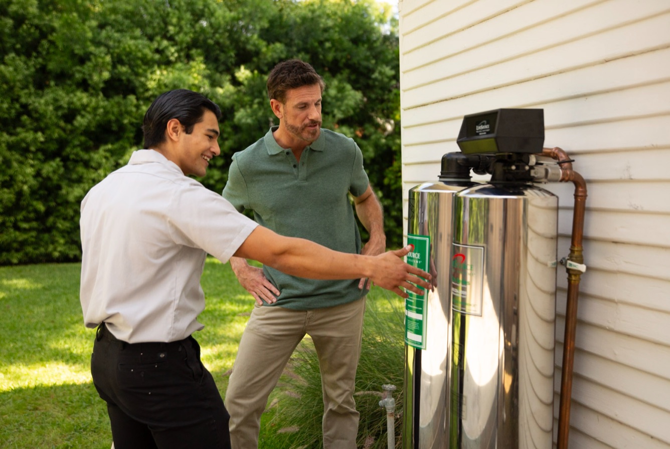 LifeSource specialist reviewing a whole house water system with a homeowner