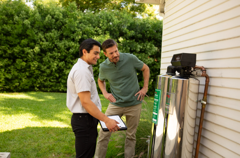 Installer explaining the completed LifeSource system to a homeowner