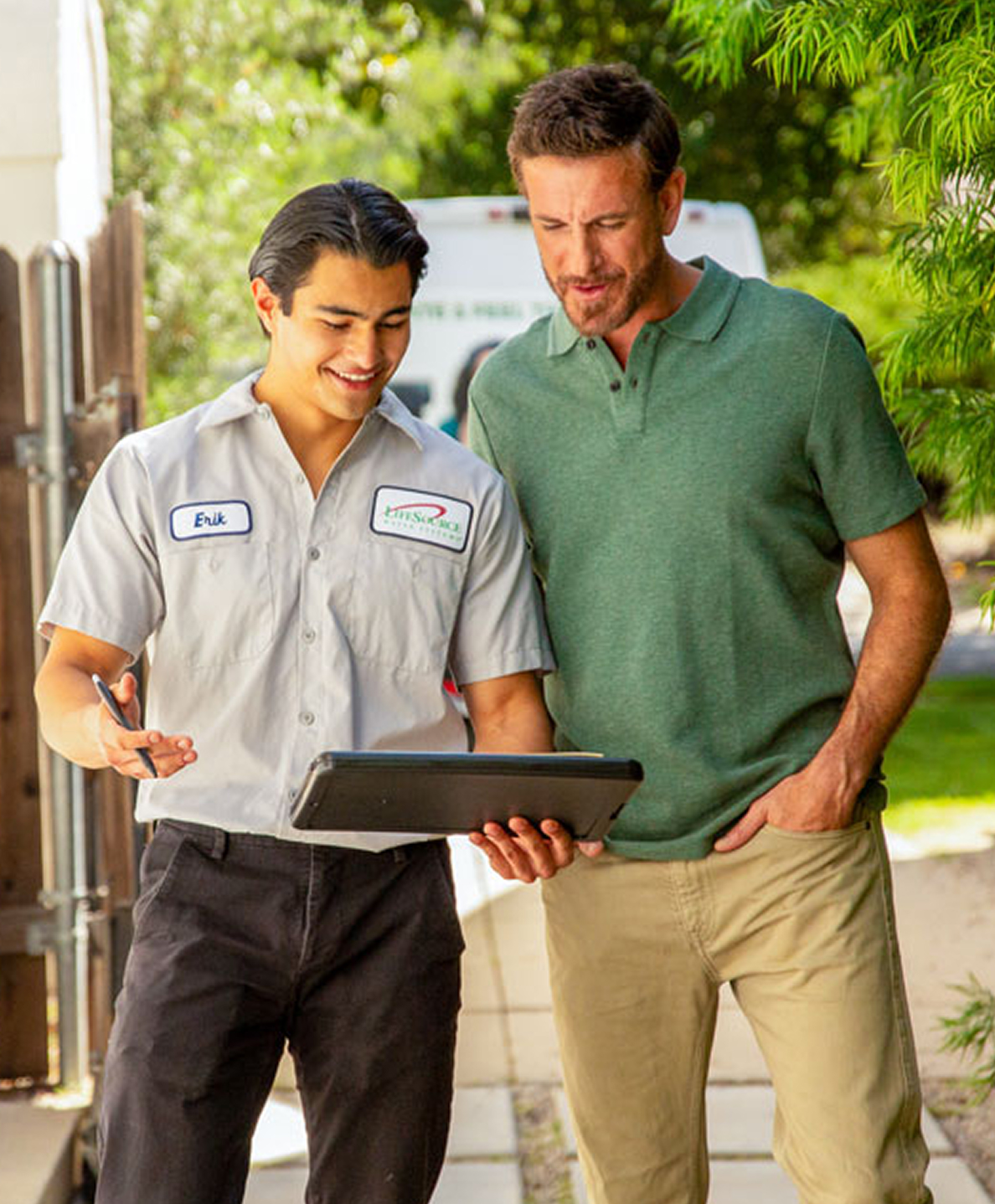 LifeSource technician reviewing installation details beside service van