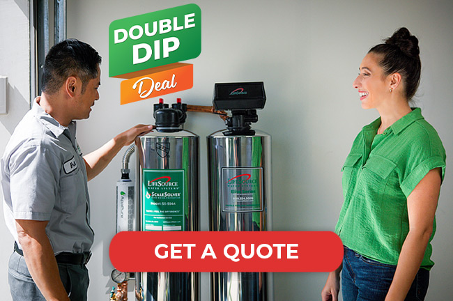 Man showing a woman a LifeSource water filtration system