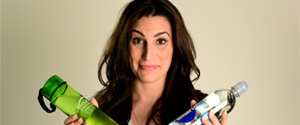 woman holding two different bottles of water in her hands
