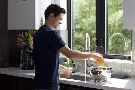 man washes dishes