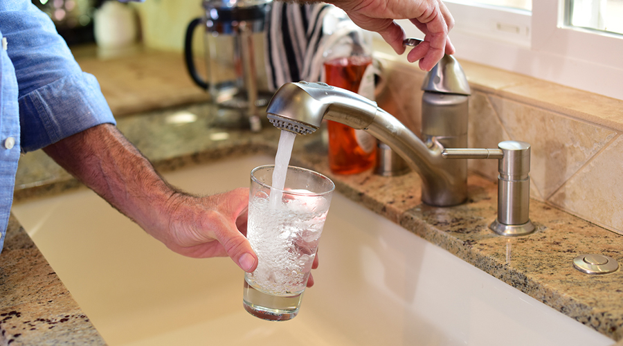 a man fills a glass with water