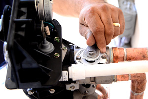 a mechanic installing lifesource water tank