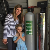 Evan and Amanda next to lifesource water tank