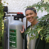 Bethany Carfaro next to her water tank