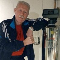 a man leaning onto lifesource water tank