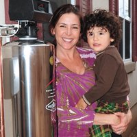 a woman and a baby besides lifesource water tank