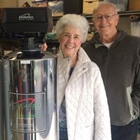 a woman and man besides lifesource water tank