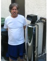 a man sitting next to his lifesource water tank