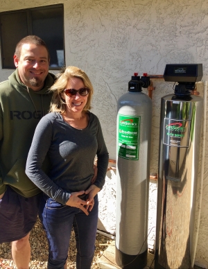 Powers family next their water filter tank